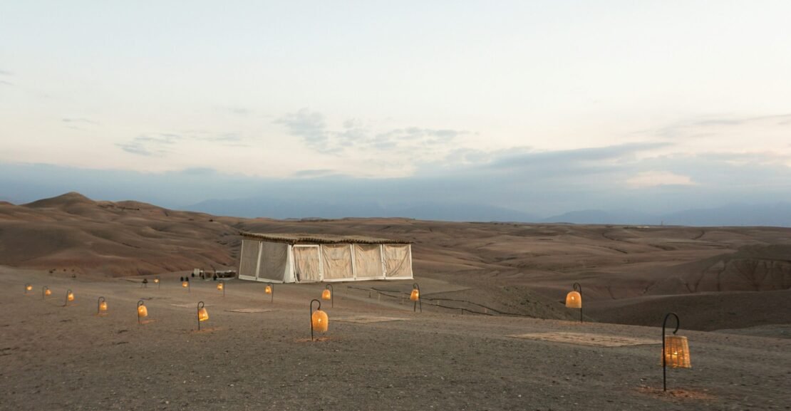 a desert area with several lit candles in the middle of it