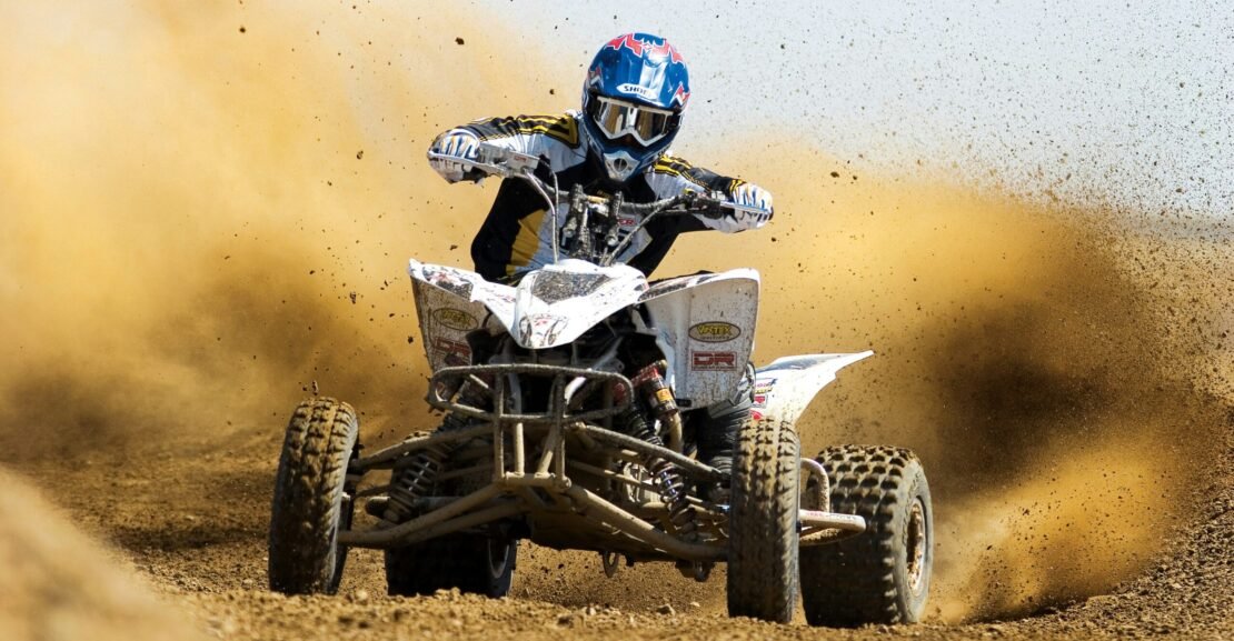 man riding ATV on the dessert